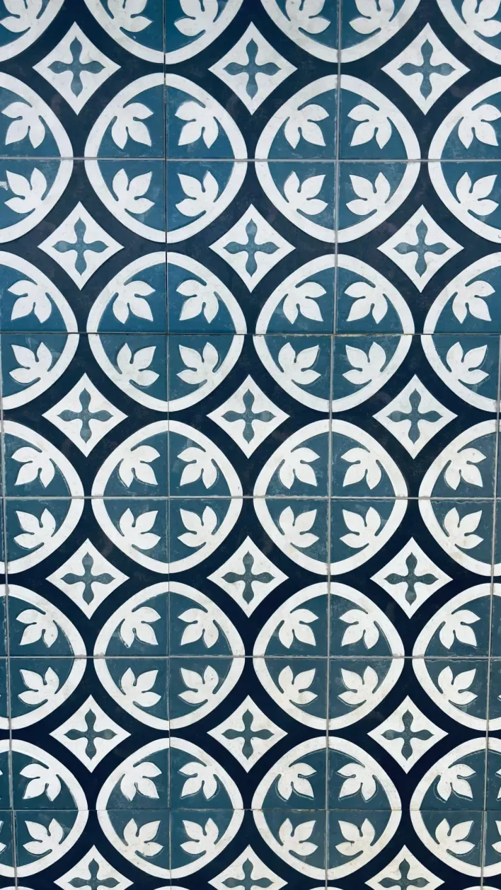 Blue and white encaustic cement tiles with floral circle motif for residential flooring