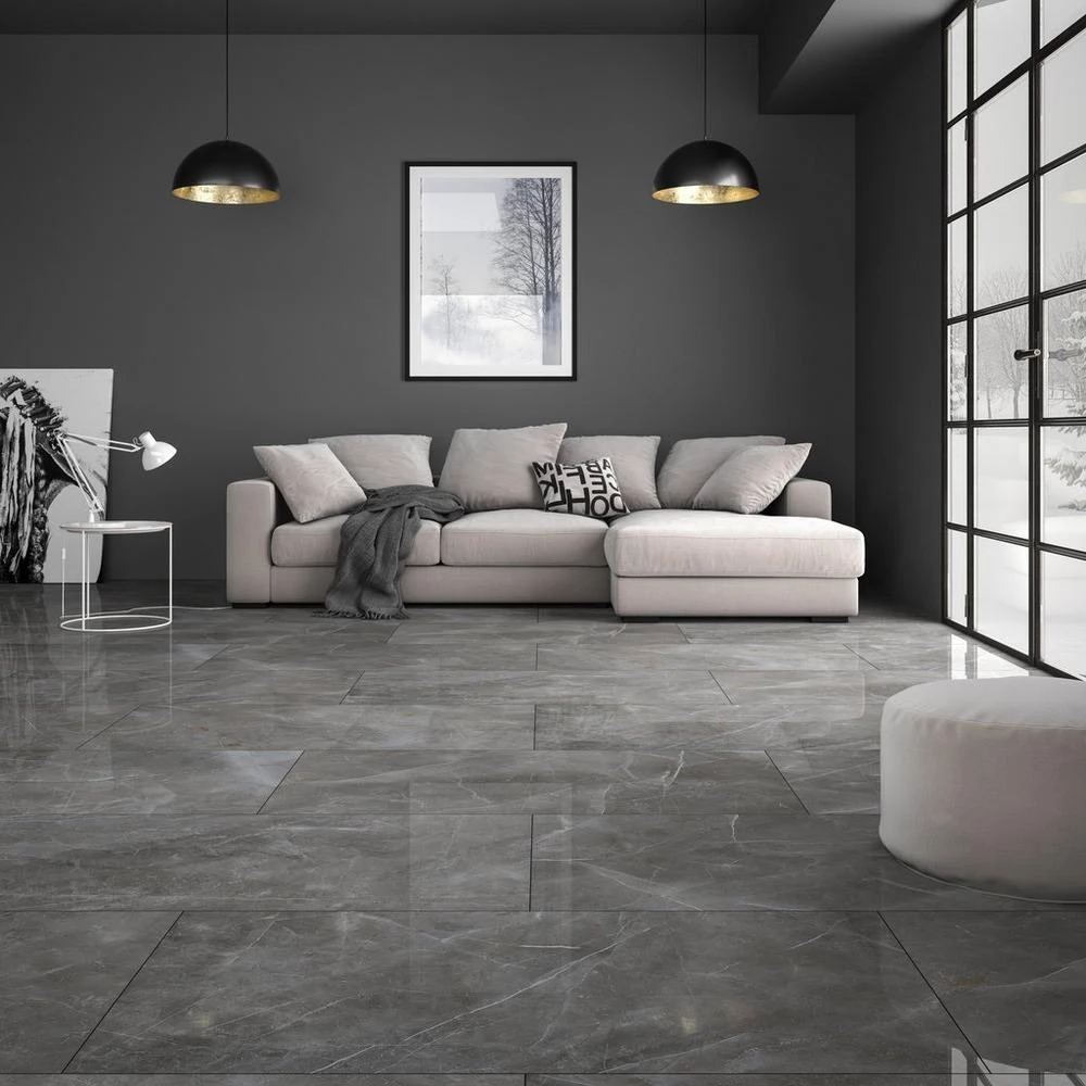 Dramatic living room with large dark gray polished marble floor tiles and pendant lighting
