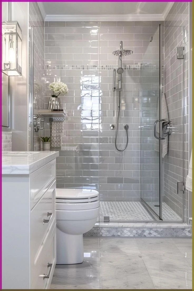 Classic gray subway tile walk-in shower with glass door and marble mosaic shower floor